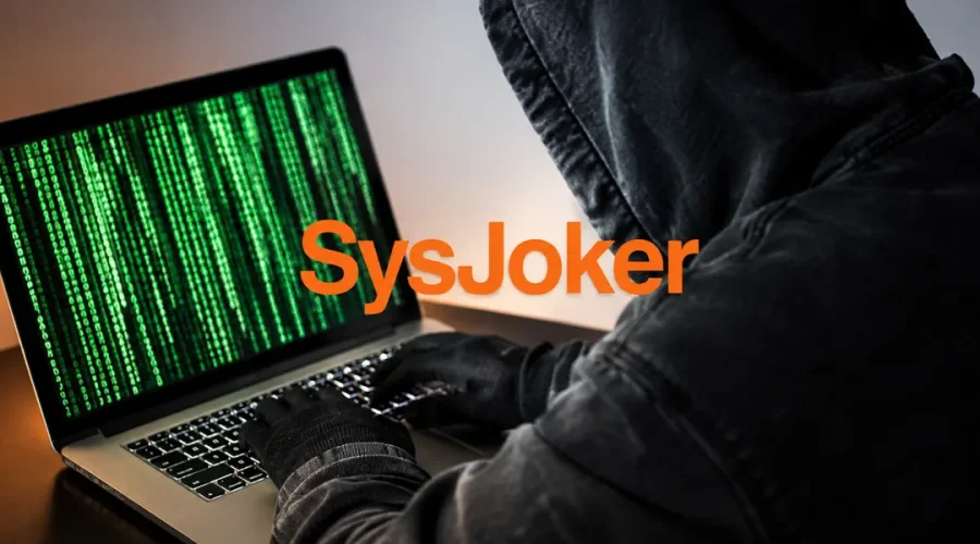 Persona frente a un portátil con el texto SysJoker